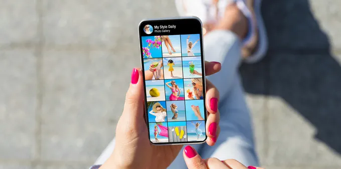 A woman browsing through pictures in her smartphone gallery