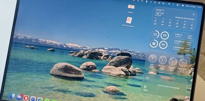 A close-up shot of a MacBook Pro running macOS Tahoe