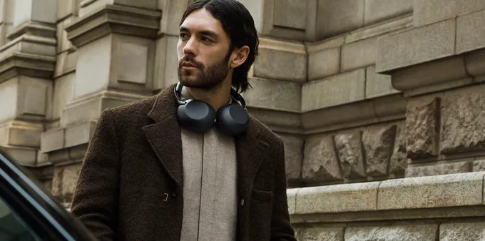 Man wearing the Sony 1000X The ColleXion headphones