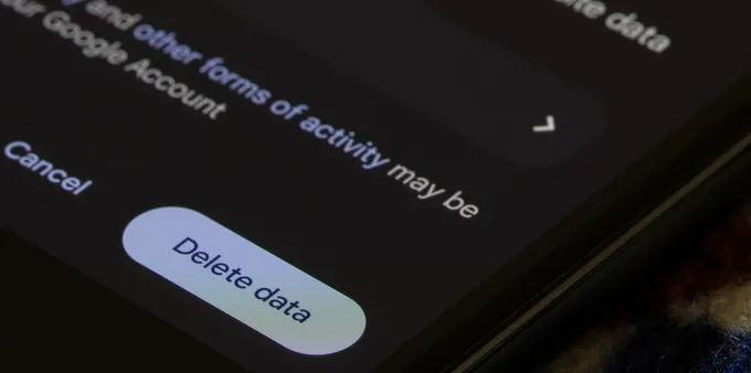 Close-up of an Android phone showing a Delete data button in app storage settings.