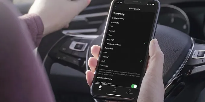 Person adjusting the Audio Quality setting in the Spotify app on iPhone.