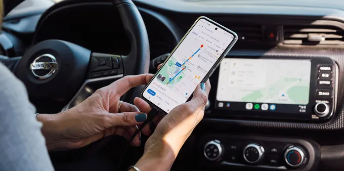 A woman using Android Auto via USB on the car's infotainment system.